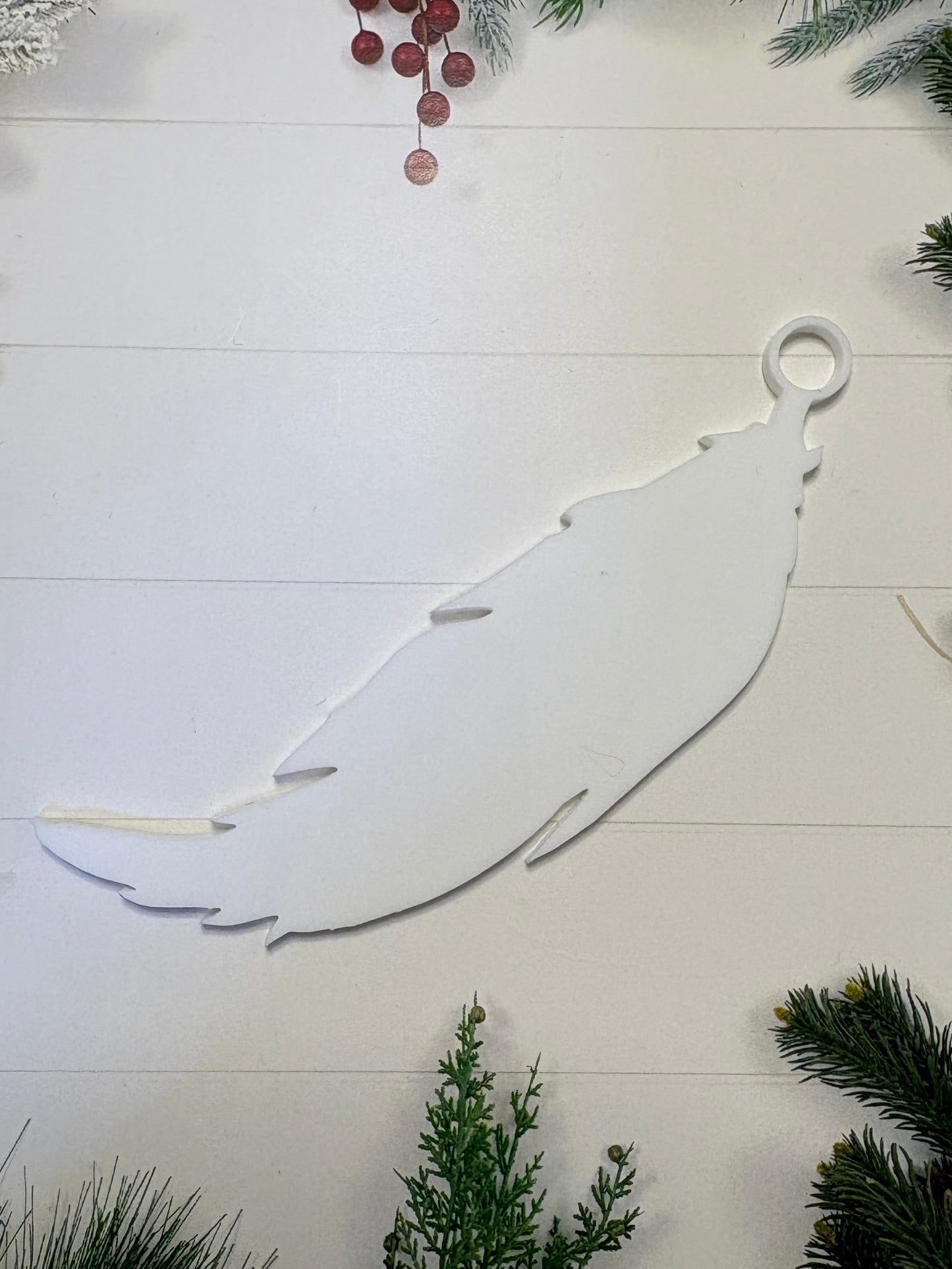 Decorative feather ornament on a white, wooden or mirror material